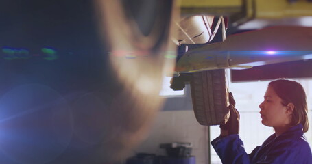 Poster - Image of light trails over biracial female mechanic reapiring car