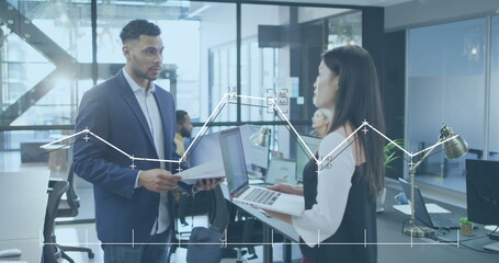 Poster - Image of graph with changing numbers over diverse coworkers discussing reports in office