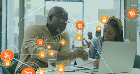 Poster - Image of connected icons over diverse coworkers discussing reports on laptop in office