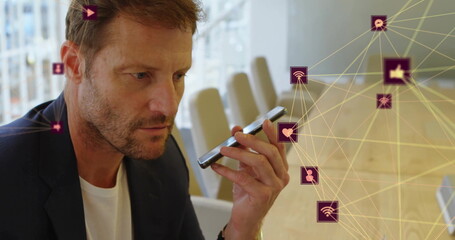 Poster - Image of connected icons globes over caucasian man talking on speaker of cellphone
