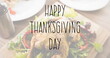 Image of happy thanksgiving day text over thanksgiving meal in background