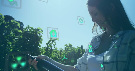 Poster - Image of ecology icons over caucasian woman with bottle of wine