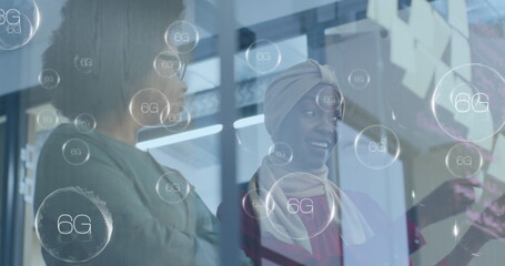 Poster - Image of multiple 6g text banners over two african american women discussing over memo notes