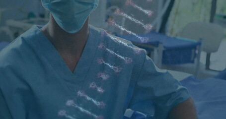 Poster - image of dna rotating over caucasian female surgeon in face mask