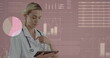 Caucasian nurse, with blonde hair, is reviewing data on tablet