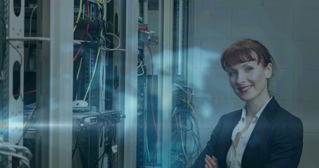 Canvas Print - Image of light trails over caucasian female worker in server room