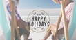Image of happy holidays over happy diverse senior couple on beach
