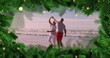 Image of fir tree frame over happy diverse senior couple danging on beach