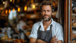 © M Grayson - A baker standing at the door of his bakery, with a confident attitude