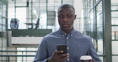Poster - Image of social media icons on african american man drinking coffee using smartphone at office