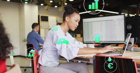 Poster - Image of icons over african american businesswoman using laptop at office