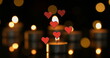 Image of hearts over spots and candles