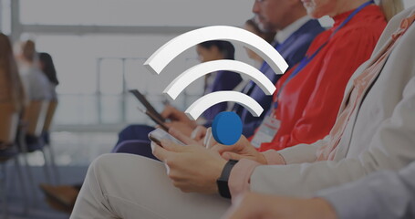 Poster - Image of wifi icons over diverse business people using electronic devices