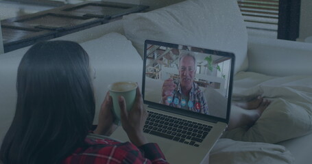 Wall Mural - Image of data processing over caucasian woman having laptop image call with senior man