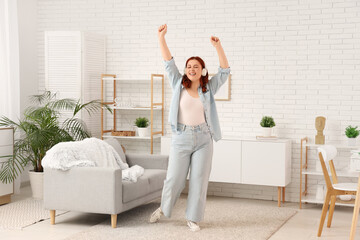 Sticker - Young woman in headphones dancing at home