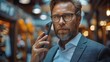 © Vilaysack - A man in a suit is talking on the phone in a public place.