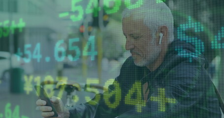 Canvas Print - Image of trading board, senior caucasian man wearing headphones and scrolling on cellphone