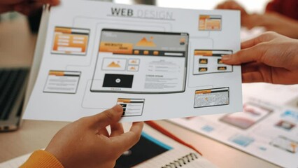 Excellent startup company employee presenting user interface prototype for mobile application or website to smart manager in office. UX UI designer pointing web page icon design and explain. Synergic