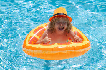 Wall Mural - Kid boy relaxing in pool. Child swimming in water pool. Summer kids activity, watersports.