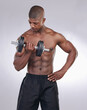 African man, dumbbell and exercise in studio with thinking, progress and development by white background. Person, bodybuilder and strong with workout, fitness and training for healthy body in gym