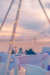 Idyllic table setup wedding ceremony on sunset beach. Romantic destination dining, couple anniversary romance celebration. Love arrangement togetherness dinner on island shore. Amazing sky sea view