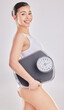 Woman, studio and portrait with scale or lose weight for body goal, target for health with smile. Female person, happiness and white background with underwear for results, self care or transformation