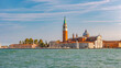 Venice, Italy. Beautiful Church of San Giorgio Maggiore and its Bell Tower at sunset illumination, and blue sky