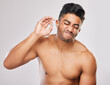 Man, hygiene or cleaning ear with bud in studio white background for model, freshness and cosmetics. Male person, topless and grooming with cotton for self care, wax removal and wellness or comfort