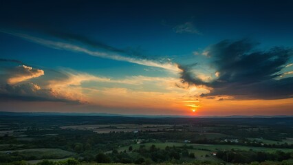 Wall Mural - Sunset over a plain with beautiful clouds in sky. Majestic and unique clouds sun going down landscape 4k image. Evening view in nature dawn