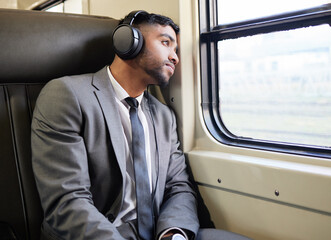 Wall Mural - Commute, headphones and businessman in train with music for streaming law podcast, listen and morning travel. Indian male worker, audio and thinking lawyer on subway for job interview with anxiety