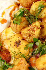 Poster - young fried potatoes with sauce and fried egg in a plate