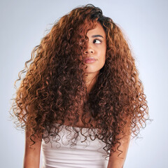 Poster - Beauty, curly or haircare and frustrated woman in studio on gray background with moody expression. Annoyed. hair and salon with African model looking unhappy at aesthetic or cosmetology routine