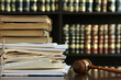 Legal Documents, Stack of law books and court papers emphasizing legal research and documentation.