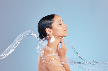 Poster - Woman, water splash and shower with cleaning in studio for hygiene, bacteria and dirt by blue background, Girl, person and model for hydration, profile and stop germs for healthy body for skincare