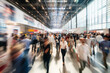 © fotogurmespb - Dynamic bustling crowd of people walking around a convention hall at a tech conference or expo