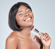 Black woman, makeup brush and happy in studio with beauty, change and foundation by background. Girl, person and glow with tools, cosmetics with product for facial skin with powder for aesthetic