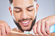 Brushing teeth, toothbrush and man in studio for wellness, fresh breath and oral care on grey background. Toothpaste, smile or model with bamboo product for mouth, cleaning or bacteria prevention