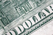 Macro image of one hundred US Dollar bill with description: DOLLAR