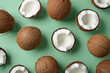 Whole and halved coconuts pattern on a green background