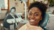 © sommersby - A woman seated in a dentist chair, smiling as she receives dental treatment
