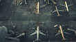 A bird's-eye view of airplanes at a bustling airport terminal, showcasing the complexity of air travel.