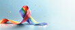 A rainbow ribbon is on a blue background with colorful confetti