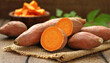 © Bill - Raw sweet potatoes on burlap, blurred background.