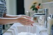 cropped shot of a woman maintaining hands hygiene and washing hands with soap in the sink