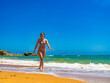 Summer holidays - beautiful woman walking on sunny beach
