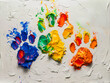 A colorful painting of paw prints on white.