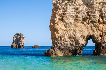 Wall Mural - Balanced complementary symmetry of rocks at a heavenly beach near Portimão, Algarve, Portugal