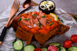 Baked sweet potato stuffed with hot smoked trout, sour cream sauce and topped with green onion