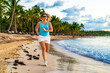 Mid-adult beautiful woman running on sunny beach
