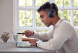 © peopleimages.com - Laptop, headphones and man with planning at desk for freelance job, review and multimedia research. Online, remote work and person with technology at home for web design, idea and listening to music